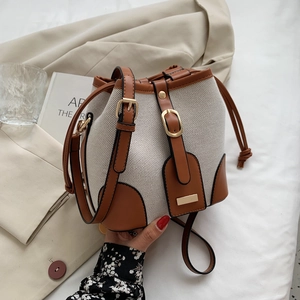 Retro canvas bucket bag with brown leather trim and drawstring for casual summer wear