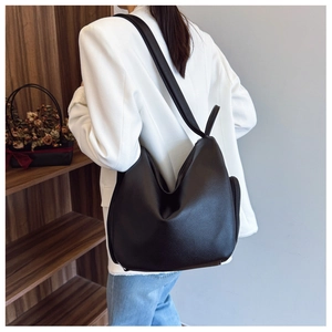 Litchi texture black leather shoulder bag styled with white blazer for daily commute