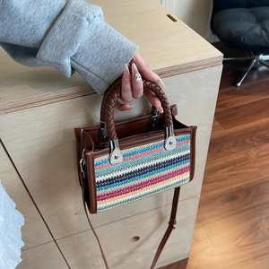 Colorful striped woven underarm bag with top handle and adjustable shoulder strap