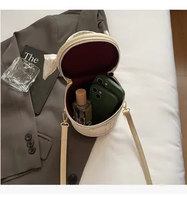 Detailed view of the spacious inner compartment of the cream woven bucket bag