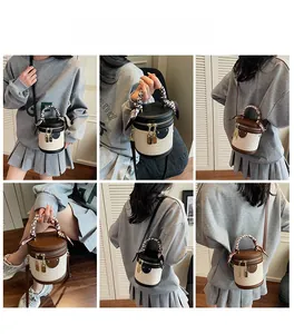 Detail shots of quilted bucket bag with silk scarf handle and metal lock closure