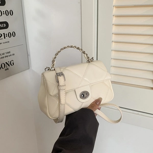 Elegant off-white quilted crossbody bag with gold chain handle and metal twist lock