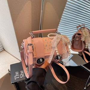 Pink pillow shoulder bag with pearls, lace bow, and rhinestone buckle for women