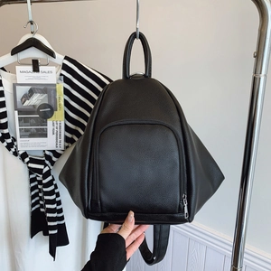 Versatile black matte backpack for women featuring a unique trapezoid shape and zip pocket