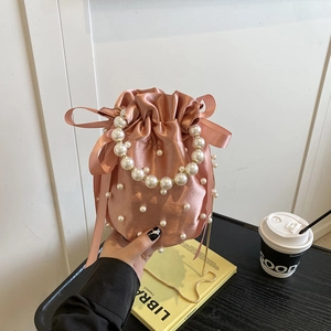 Pink satin pleated bucket bag with pearl handle and bow for elegant women