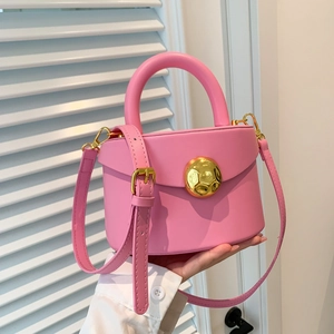 Pink semi-cylindrical leather handbag with gold wavy buckle and adjustable strap