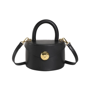 Minimalist black cylinder bucket bag with matte PU leather and gold hardware