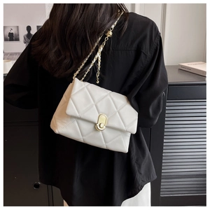 White quilted crossbody bag featuring a golden twist-lock and leather chain strap