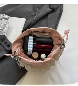 Interior view of pink drawstring bucket bag showing large capacity for phone and wallet