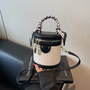 Fashion monochrome bucket bag with woven texture, silk scarf handle and gold hardware detail