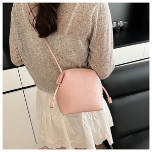 Pink lychee texture crossbody bag shown on model for a trendy minimalist daily look