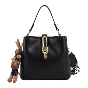 Black leather bucket bag with wide geometric strap and cute brown rabbit charm pendant