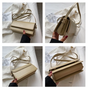 Detail view of khaki crossbody bag showing the triple-layer gusset design and smooth texture