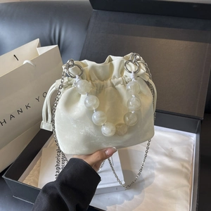 Chic cream drawstring bucket bag with marble bead handle in a premium gift box