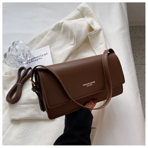 Detail view of the brown leather baguette bag with gold FASHION & BAGS logo branding