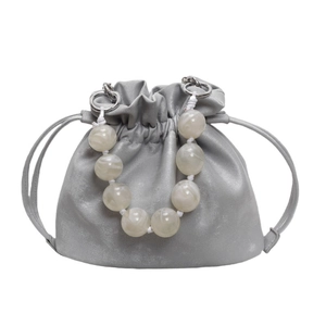 Chic grey drawstring bucket bag with marble bead handle and crossbody strap accessory