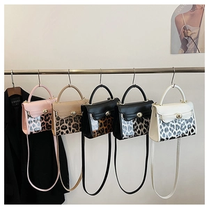 Serie di mini borse a tracolla leopardate in vari colori su un espositore in metallo