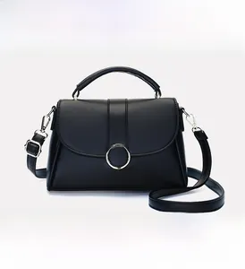 Detail of black leather underarm bag with metal buckle and adjustable shoulder strap