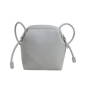 Minimalist light blue crossbody bag in litchi grain leather with geometric 3D design