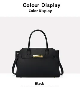 Detail of black lychee grain leather tote bag featuring gold lock and horizontal strap