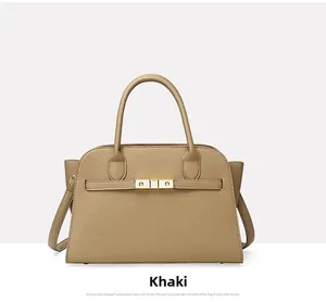 Detail of khaki lychee grain leather tote bag with gold square buckle and side wing design