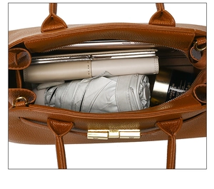 Top view of the spacious interior of a brown lychee pattern tote bag with daily items