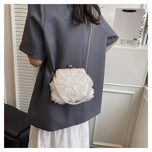 Detailed view of 3D rose flower evening bag with white pearls and gold metal clasp