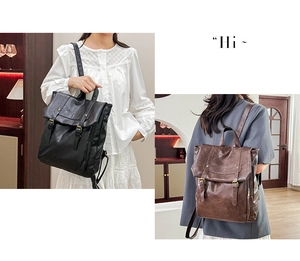 Detail view of vintage style faux leather backpacks in black and brown with buckle straps