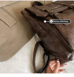 Detail view of meticulous stitching on vintage brown leather backpack with metal buckles