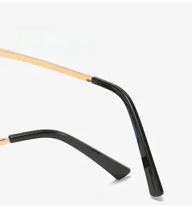 Detail of curved golden metal temples with black tips for a comfortable fit