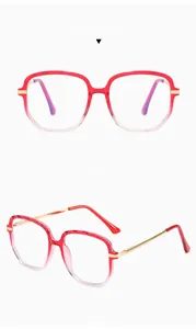 Macro view of gradient red TR90 frames with faceted edges and slim gold metal temples