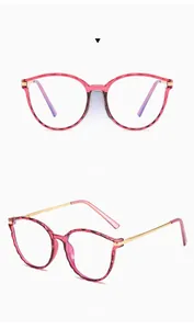 Detail view of translucent red geometric TR90 frames with slim gold metal temples
