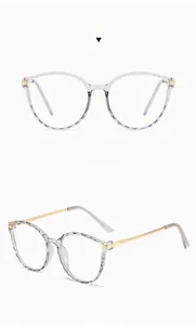 Detail view of gray TR90 polygonal frames with slim gold metal temples and faceted texture