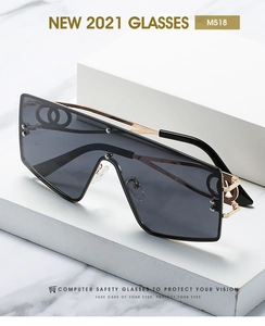 Macro detail of gold metal temples with hollow geometric patterns on oversized sunglasses