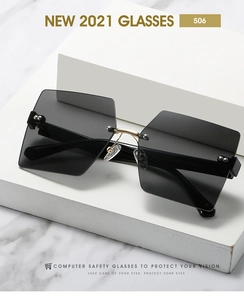Macro detail of rimless square sunglasses with gray lenses and gold metal nose bridge