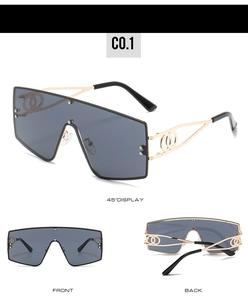 Detail view of large shield sunglasses with hollowed temples and dark gray lenses