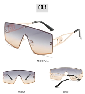 Detail view of large frame sunglasses featuring gradient lenses and hollow metal temples
