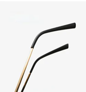 Detail of ergonomic TR90 cat-eye frame temples with golden metal and black finish