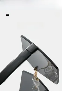 Detail of rimless square sunglasses hinge featuring gold metal hardware and elastic material