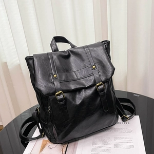Vintage black faux leather backpack with classic buckle straps and a campus style aesthetic