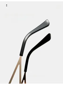 Detail of curved golden metal temples and black tips for comfortable sunglasses fit