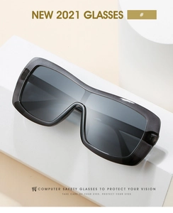 Close-up of translucent grey shield sunglasses on geometric props for eye protection