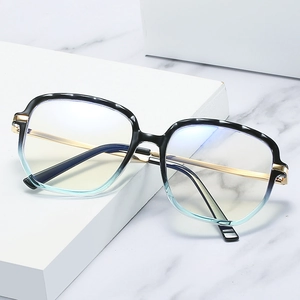 Minimalist gradient TR90 blue light blocking glasses with golden metal temples on marble