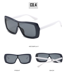 Detailed views of oversized sunglasses in contrast black and white with gray lenses