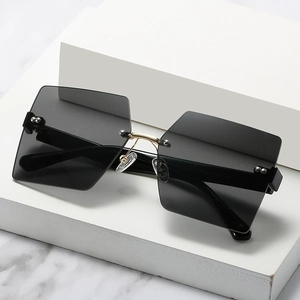 Fashionable rimless oversized square sunglasses with gold metal accents and dark grey lenses