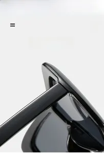 Detail view of high-quality hinge structure on oversized black oversized sunglasses
