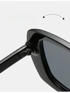 Macro view of durable metal reinforced hinge on glossy black oversized sunglasses