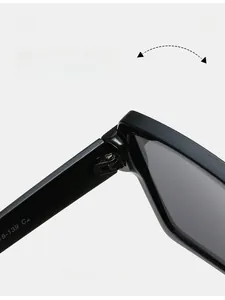 Detailed close-up of the durable metal hinge and frame model coding on black sunglasses