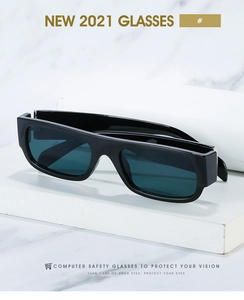 Detail of square vintage sunglasses with black thick frames on white marble base