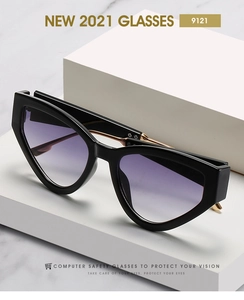 Detail of black cat-eye glasses frame with gold metal hinge and purple gradient lens